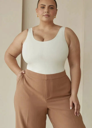 woman wearing pinsy shapewear scoop tank hourglass shapewear bodysuit in  cream