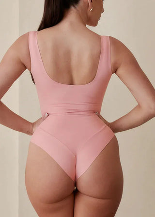 Woman wearing Pinsy Shapewear Scoop Neck Hourglass Shapewear Bodysuit in Petal Pink
