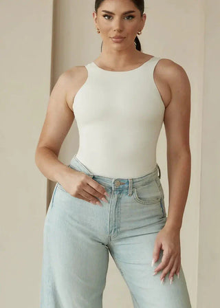 woman wearing pinsy shapewear high neck hourglass shapewear bodysuit in  cream