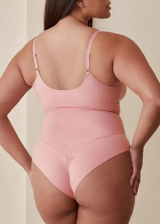 Woman wearing Pinsy Shapewear V Neck Hourglass Shapewear Bodysuit in Petal Pink