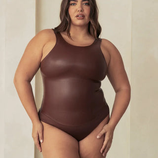 Woman Wearing Pinsy Shapewear Vegan Leather High Neck Shapewear Bodysuit in Brown