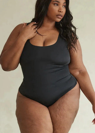 Woman Wearing Pinsy Shapewear Scoop Neck Hourglass Shapewear Thong Bodysuit in Black