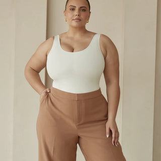 woman wearing pinsy shapewear scoop tank hourglass shapewear bodysuit in  cream