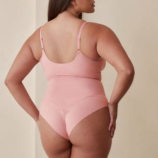 Woman wearing Pinsy Shapewear V Neck Hourglass Shapewear Bodysuit in Petal Pink