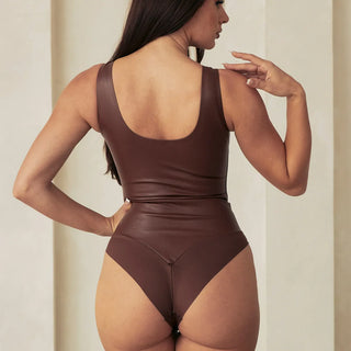 Woman Wearing Pinsy Shapewear Vegan Leather High Neck Shapewear Bodysuit in Brown